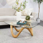 Table basse abstraite Olivia & May Cement avec base abstraite ondulée et plateau en verre triangulaire beige